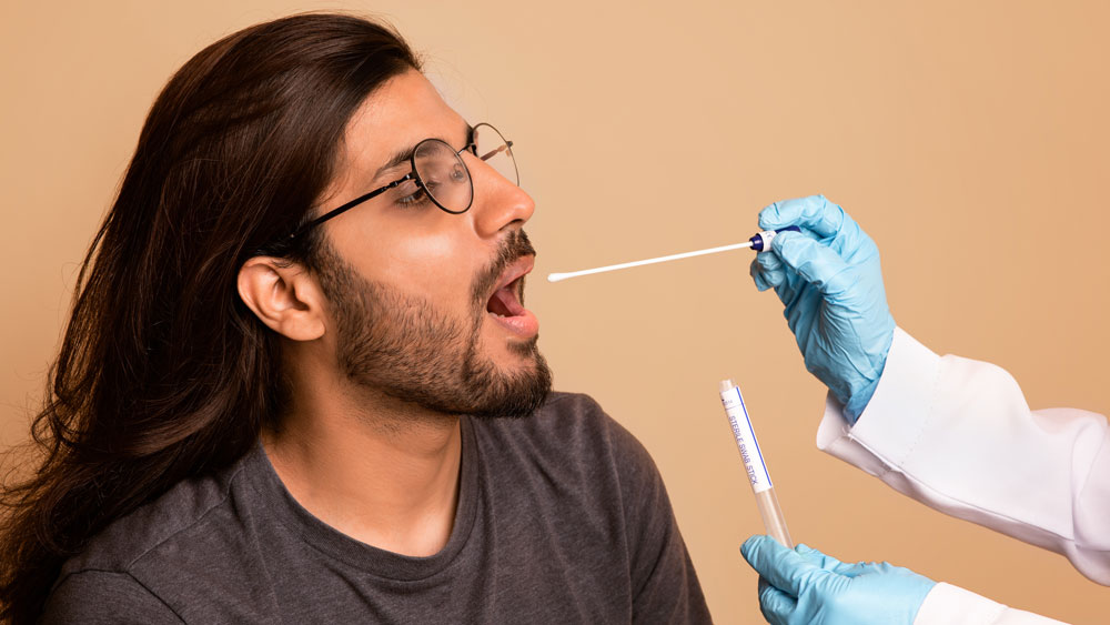 Person taking a dna test via mouth swab